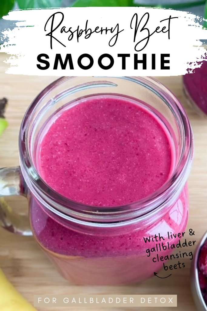 Bright pink raspberry beet smoothie in a mason jar on a wooden surface, with text overlay reading raspberry beet smoothie for gallbladder detox