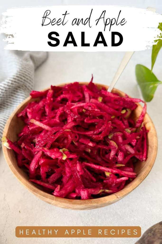 Shredded beet and apple salad in a wooden bowl.