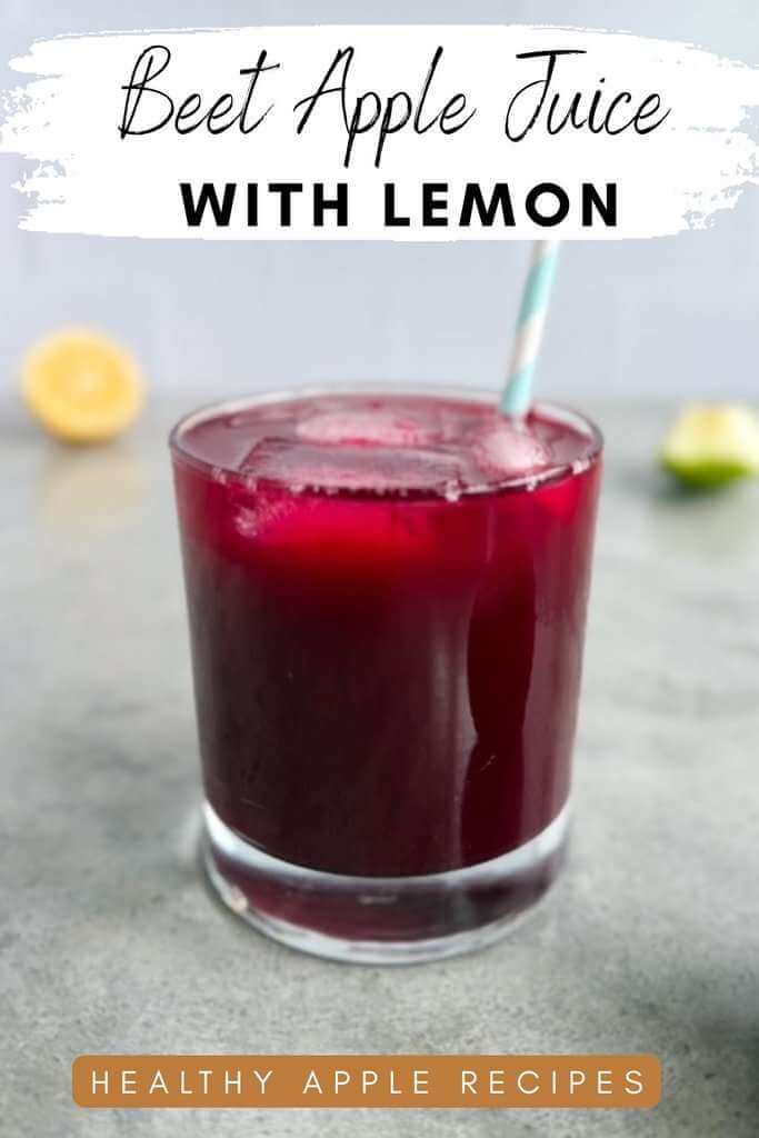 Red drink with ice cubes in a glass mugh with a stiped blue straw and lemon and apple in the background with text overlay that says beet apple juice with lemon - healthy apple recipes.